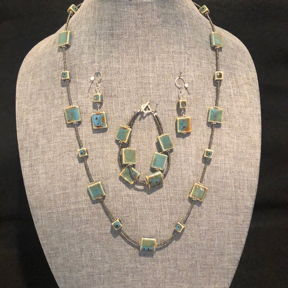 Pottery square beads fired in a natural blue/brown. Necklace/bracelet/earrings.